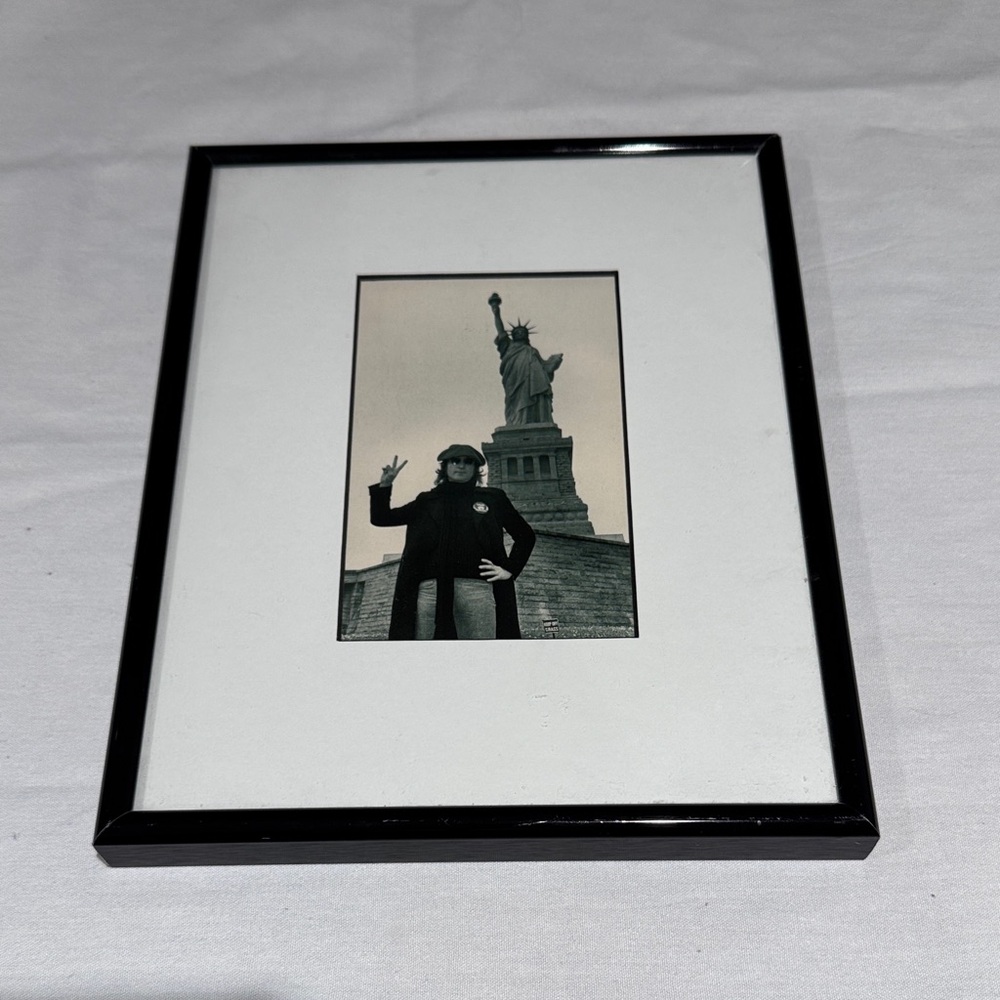 John Lennon giving the peace sign at Statue of Liberty New York. Beatles.